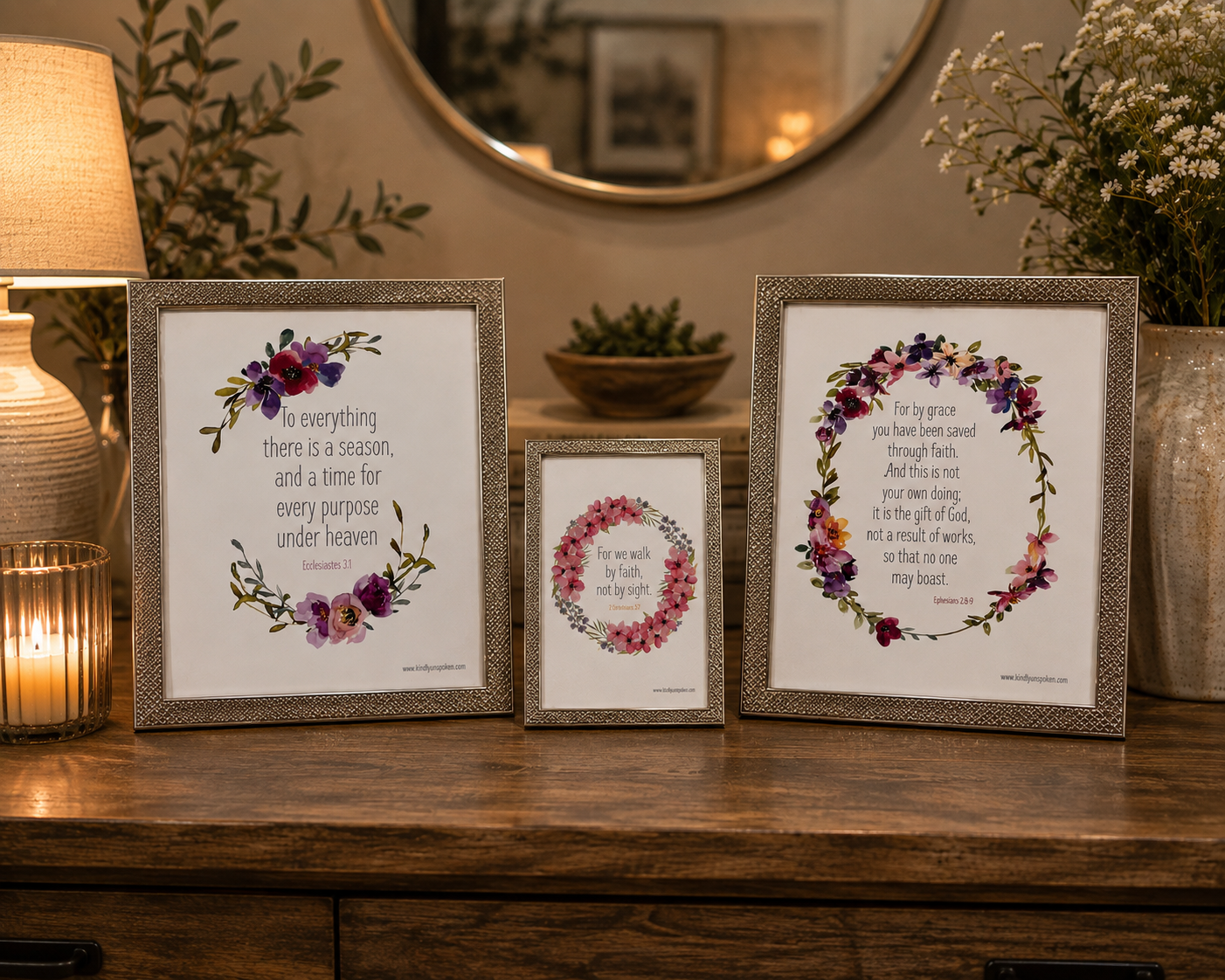 Set of three standing picture frames of varying sizes and metallic finishes Silver frame each containing a printed Bible verse adorned with watercolor floral wreaths.